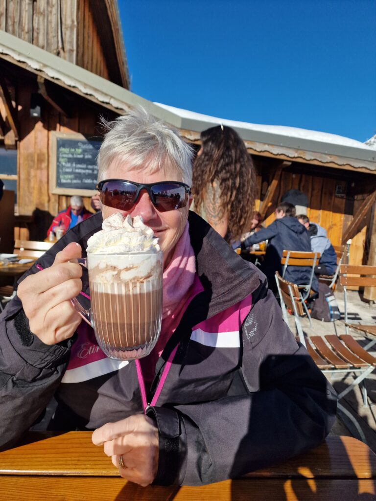 Tracy Ward drinking a hot chocolate and celebrating achievements when skiing and stepping out of comfort zone